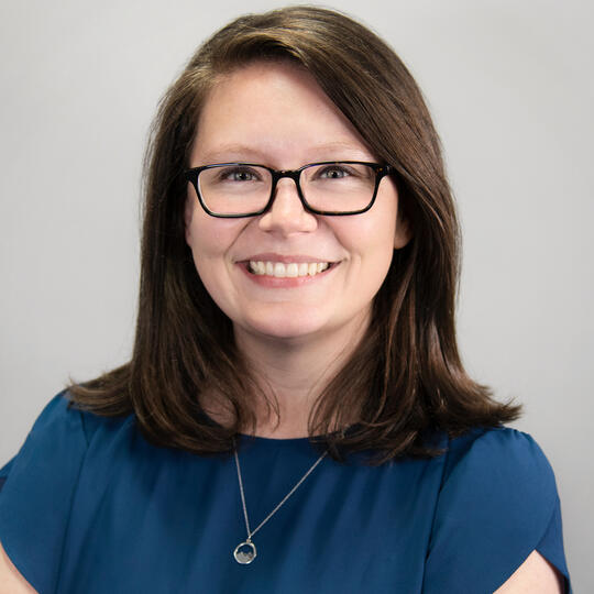 A picture of Jessica Critten, a white woman with brunette hair and glasses.